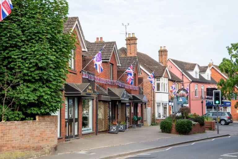 The parade of shops on Bourne End high street, hung with bunting