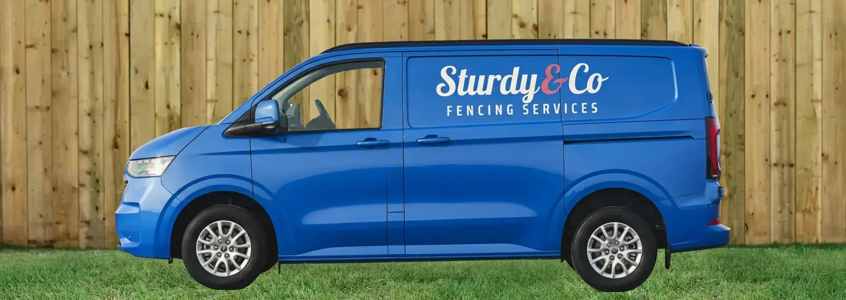 The blue Sturdy&Co Fencing Services van parked on grass in front of a closeboard fence